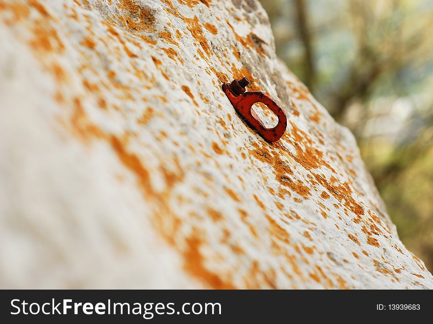 Old climbing anchor on the rocks