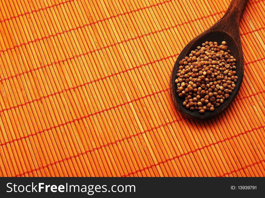 Pepper corns over orange bamboo mat