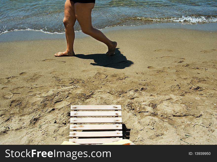 Senior woman walking on the beach