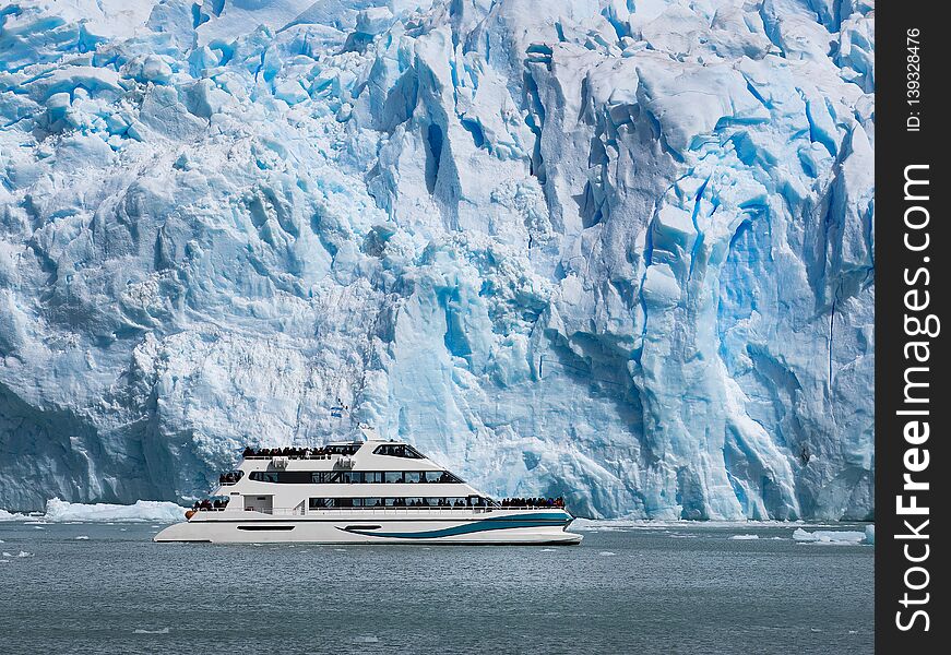 Tourist day cruise boat navigating near the Upsala glacier in Patagonia, Argentina. Tourist day cruise boat navigating near the Upsala glacier in Patagonia, Argentina