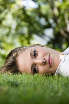 Girl Lying On The Grass Royalty Free Stock Images
