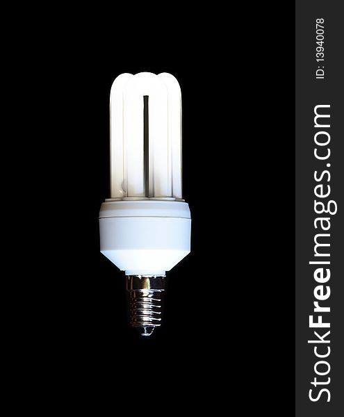 Energy saving compact fluorescent lightbulb isolated on black background. Energy saving compact fluorescent lightbulb isolated on black background