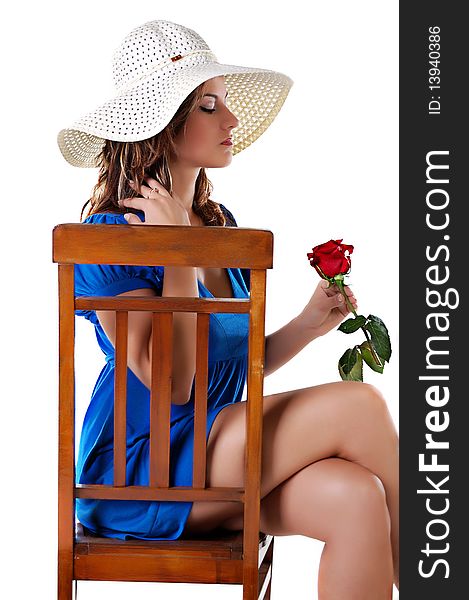 Elegant girl in hat on a chair with rose. Elegant girl in hat on a chair with rose