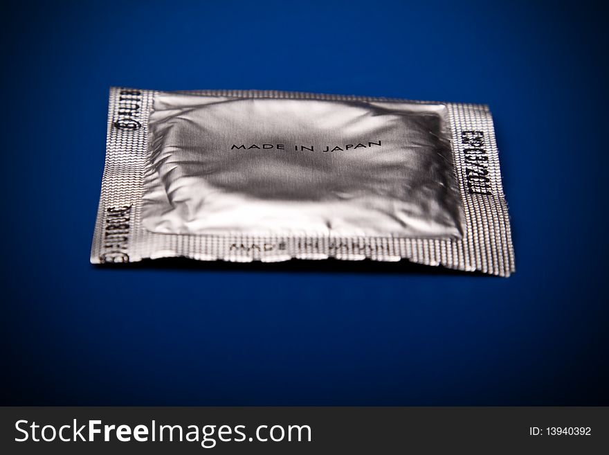 Condom in foil on a blue background