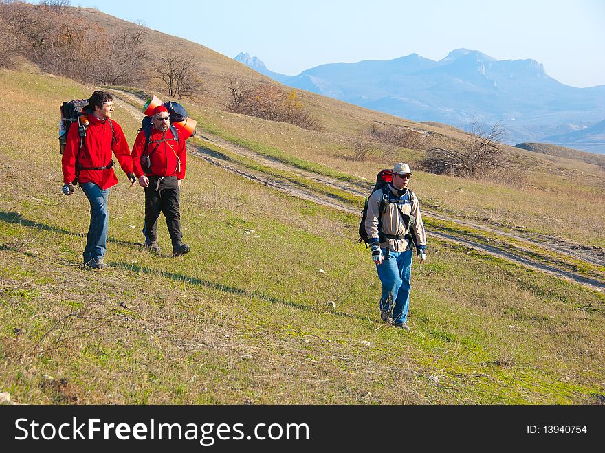 Hikers group walking in spring mountains