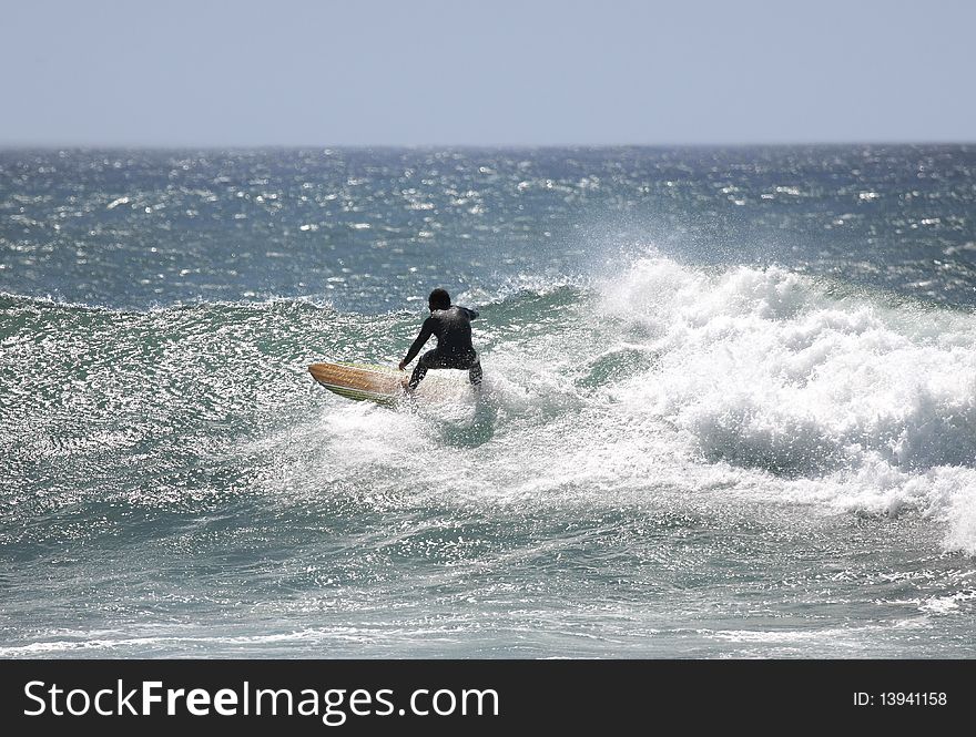 Surfer with a black suit in the wave. Surfer with a black suit in the wave