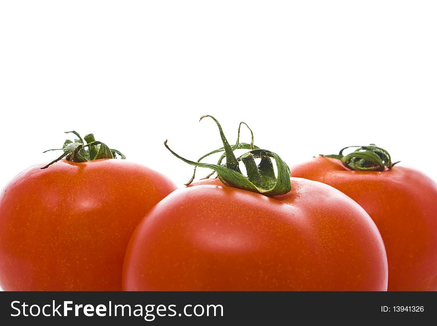 Three red tomatoes isolated on white. Three red tomatoes isolated on white