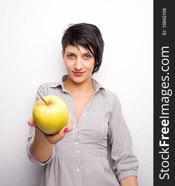 Young girl offering a yellow apple. Young girl offering a yellow apple