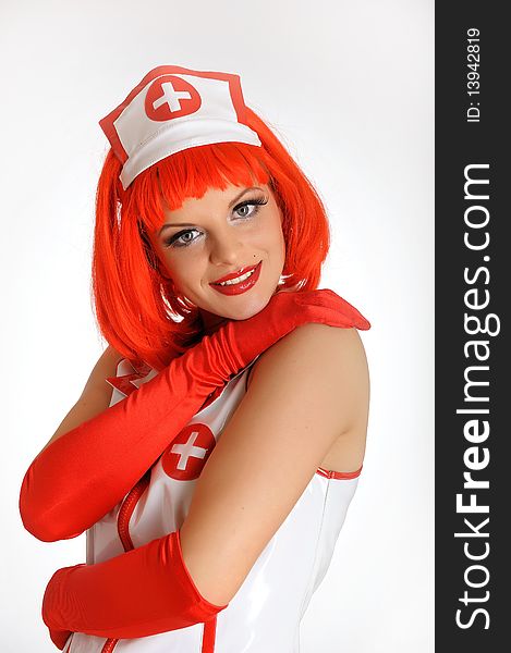 Young nurse with red hair in gloves. Young nurse with red hair in gloves