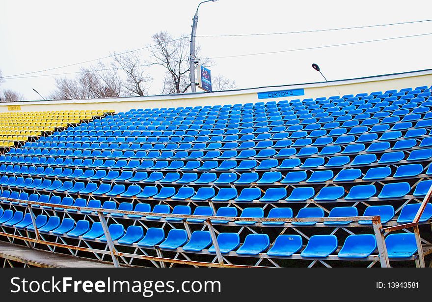 The Blue and Yellow Seats on an Empty Soccer stands