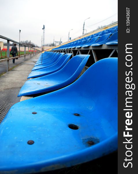 The Blue Seats in the Empty Stadium Stands. The Blue Seats in the Empty Stadium Stands