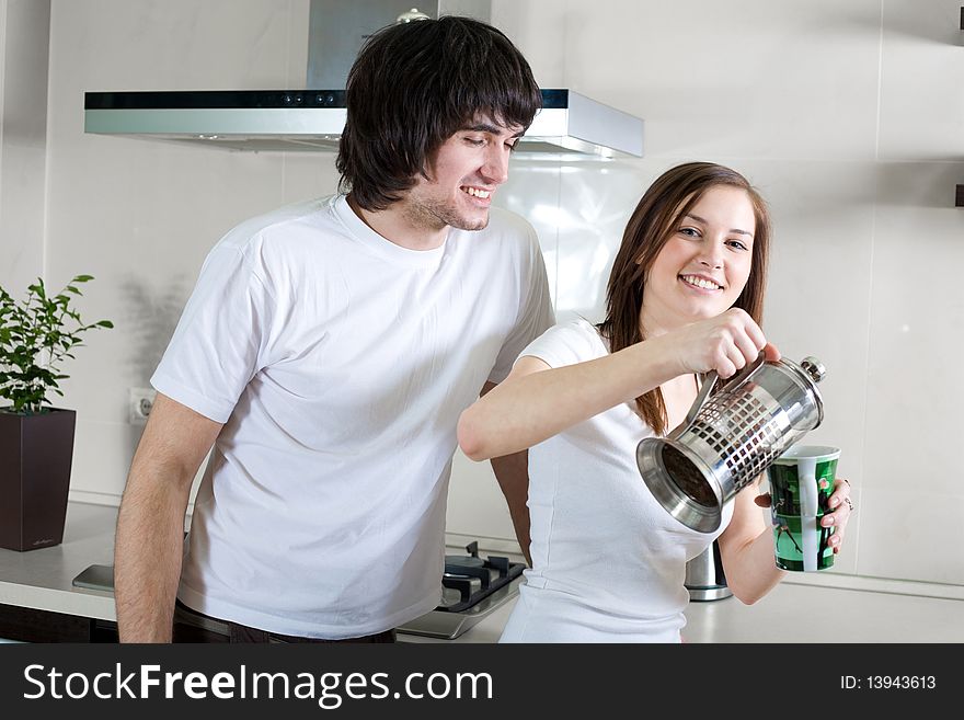 Boy with smile and beautiful girl with cup and with teapot. Boy with smile and beautiful girl with cup and with teapot