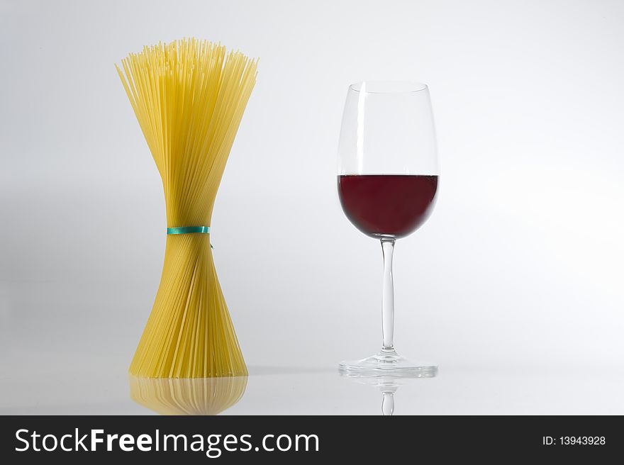 Spaghetti near a glass of red wine. Spaghetti near a glass of red wine