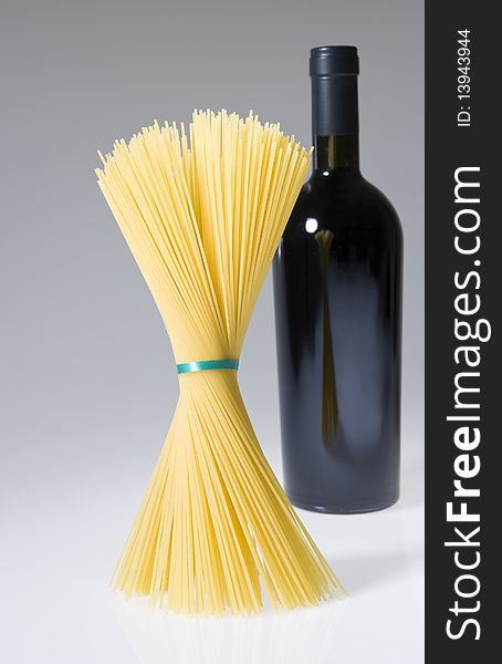 Spaghetti near a bottle of red wine. Spaghetti near a bottle of red wine