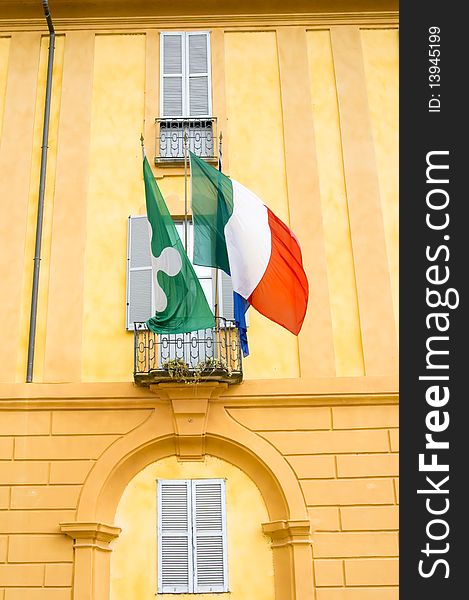 Picture of a building with Italian flag and Regione Lombardia flag. Picture of a building with Italian flag and Regione Lombardia flag