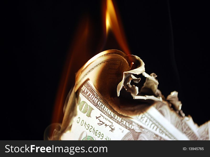 One hundred dollar bills on fire. One hundred dollar bills on fire