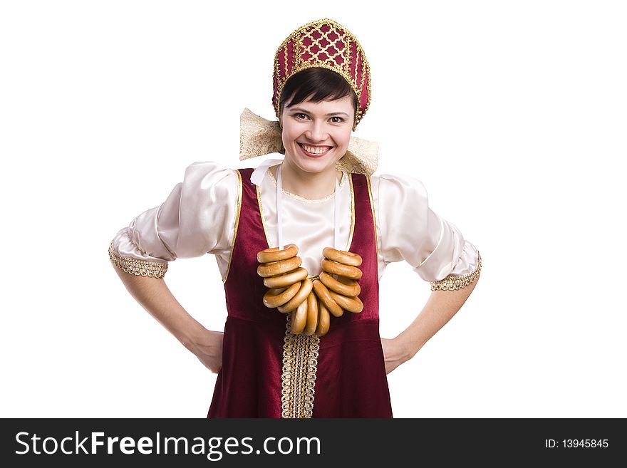 Girl standing in Russian traditional costume with bread-ring. Woman is wearing sarafan and kokoshnik . The girl in red old russian dress. Isolated on white. Girl standing in Russian traditional costume with bread-ring. Woman is wearing sarafan and kokoshnik . The girl in red old russian dress. Isolated on white.
