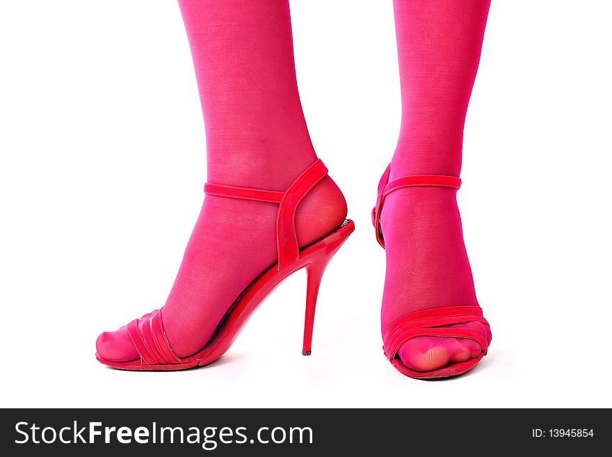 Legs in red shoes isolated over white