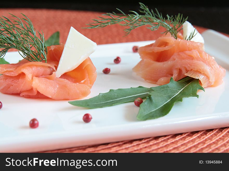 Smoked salmon rolls with butter, rocket and wild fennel. Smoked salmon rolls with butter, rocket and wild fennel