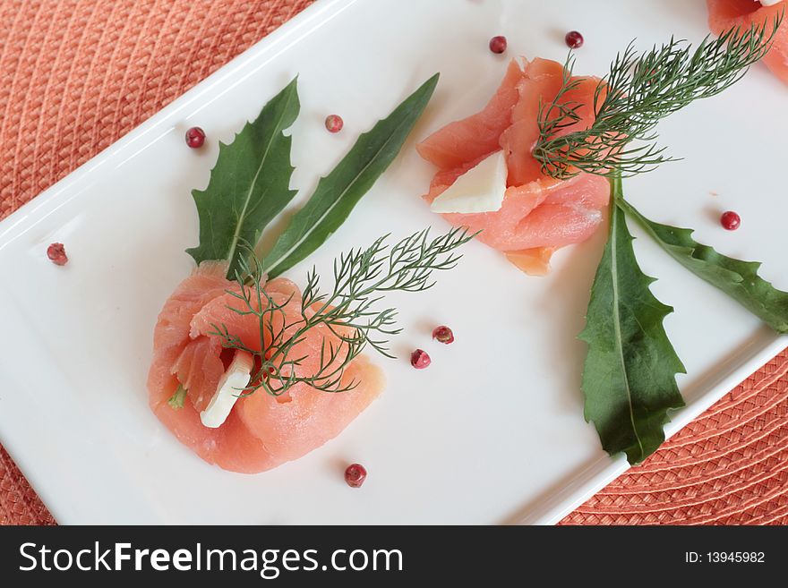 Smoked salmon rolls with butter, rocket and wild fennel. Smoked salmon rolls with butter, rocket and wild fennel