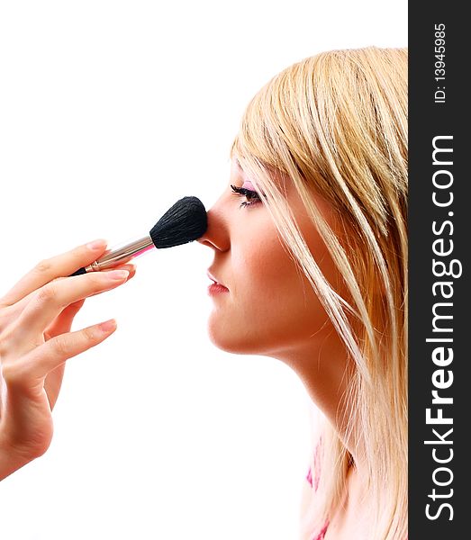 Pretty woman applying make up on a white background. Pretty woman applying make up on a white background