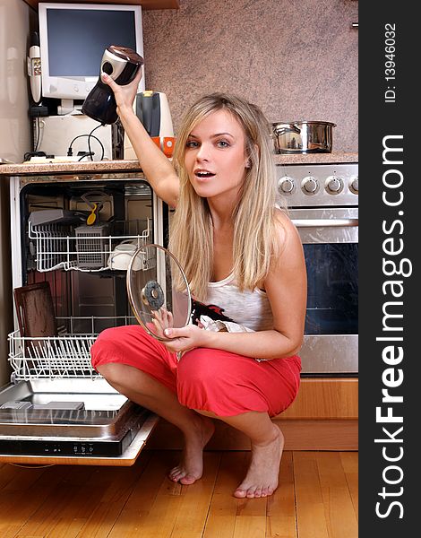 Woman cleaning kitchen at dishwasher