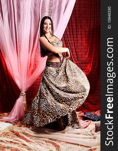 Shot of an oriental woman in a traditional costume. Shot of an oriental woman in a traditional costume.