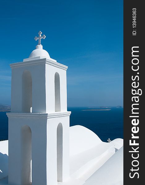 Greek church in santorini greece with a cross