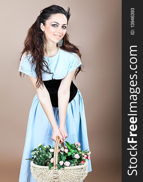 Shot of a beautiful young woman with a basket of flowers. Shot of a beautiful young woman with a basket of flowers.
