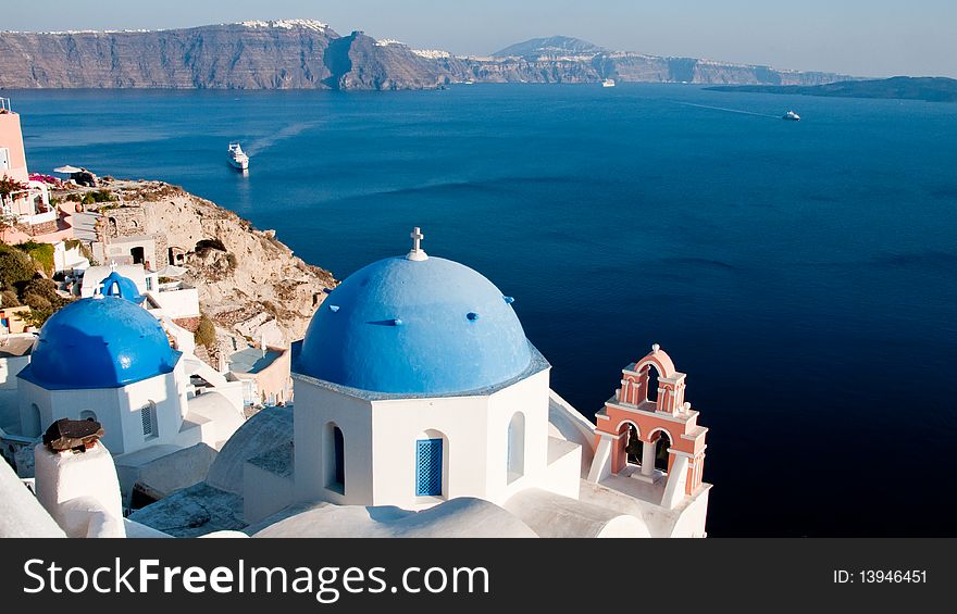 Greek church in santorini greece with a cross