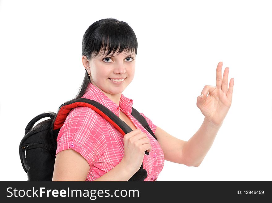 Young woman with thumbs ok; bears a backpack; isolated on a white background. Young woman with thumbs ok; bears a backpack; isolated on a white background