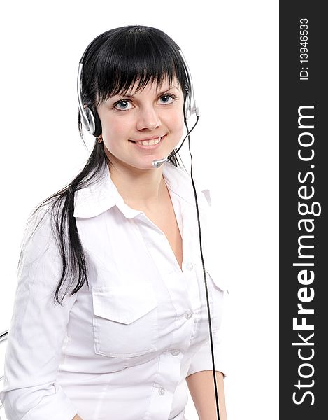 Beautiful young woman in headphones smiles in current of telephone conversation on a white background. Beautiful young woman in headphones smiles in current of telephone conversation on a white background