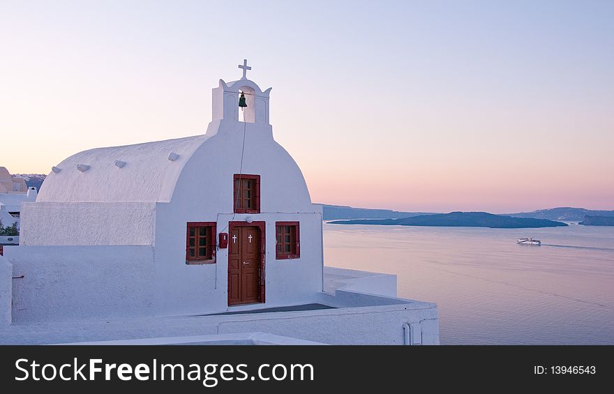 Greek church in santorini greece with a cross