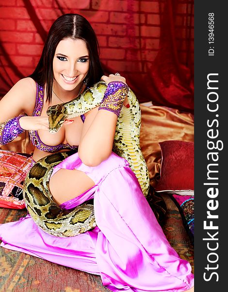 Shot of an oriental woman posing with a python. Shot of an oriental woman posing with a python.