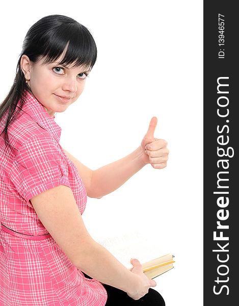 Young woman with thumbs ok; with book; isolated on a white background