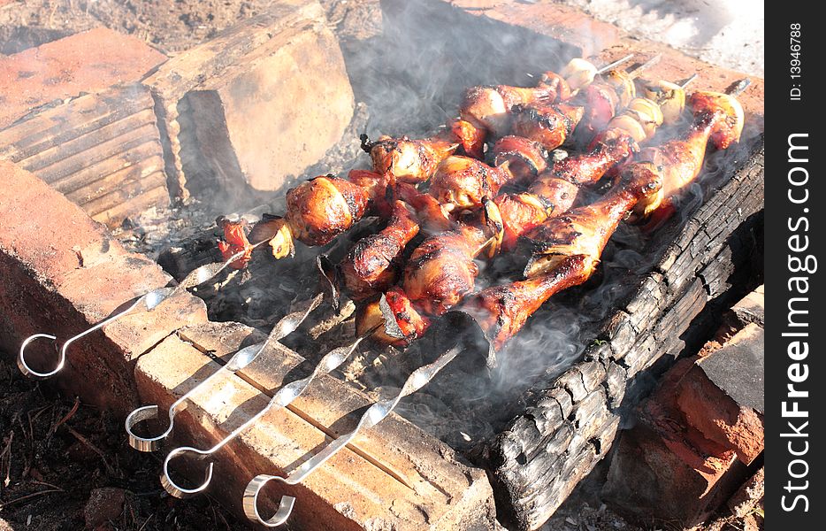 Kebab at stake. Barbecue chicken on a fire with smoke.
