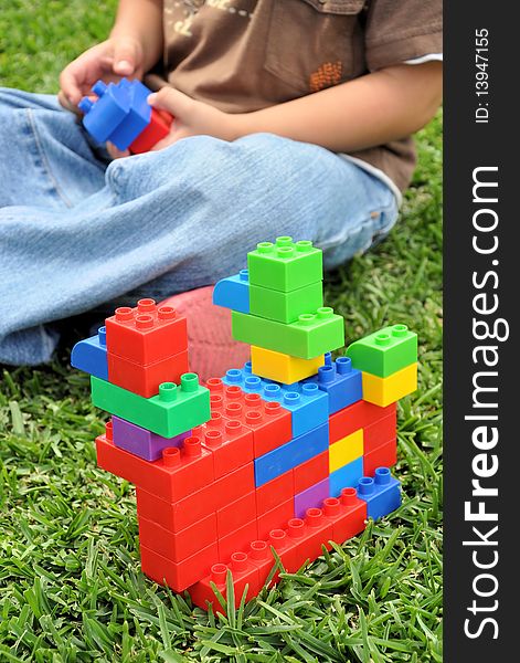 Kid enjoying and playing with a brick construction Set. Kid enjoying and playing with a brick construction Set