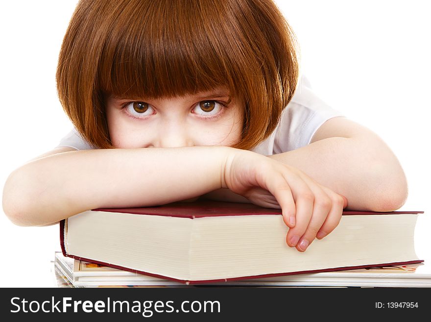 Little girl lying on books