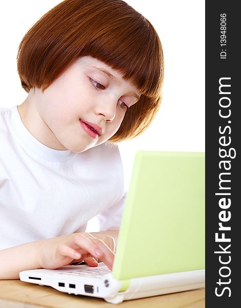 Little girl using laptop over white