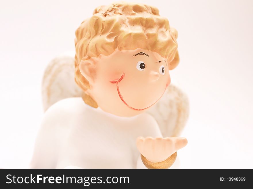 Figure of a curly-headed, childlike angel in high-key. Figure of a curly-headed, childlike angel in high-key