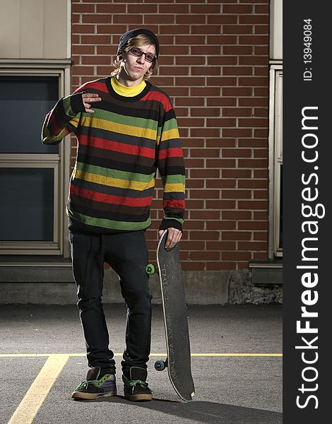 Young Skateboarder Standing With Board