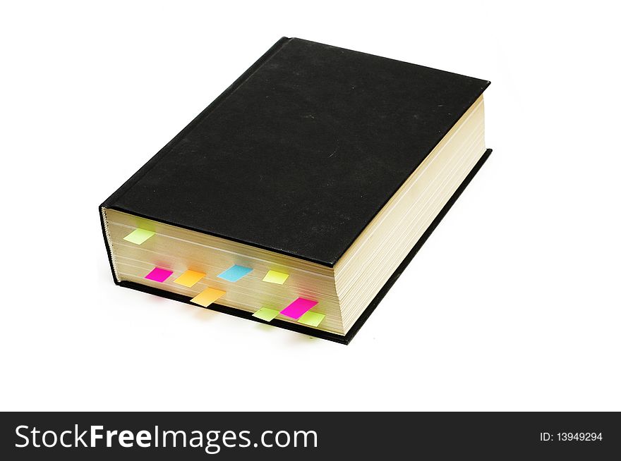 Black book with important pages marked with index bookmarks. Black book with important pages marked with index bookmarks
