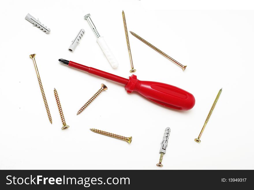 Red screwdriver and several screws. Red screwdriver and several screws