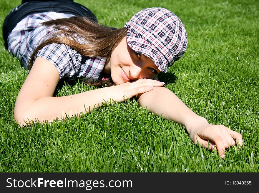 Young caucasian girl lying on the green grass. Young caucasian girl lying on the green grass