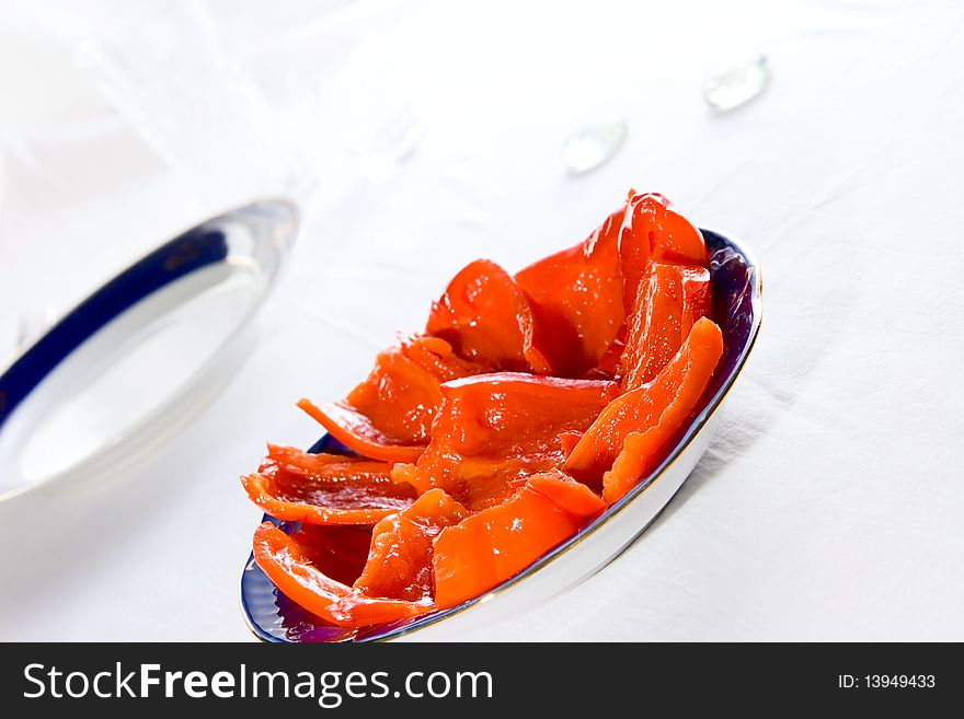 Canned red pepper on plate. Canned red pepper on plate