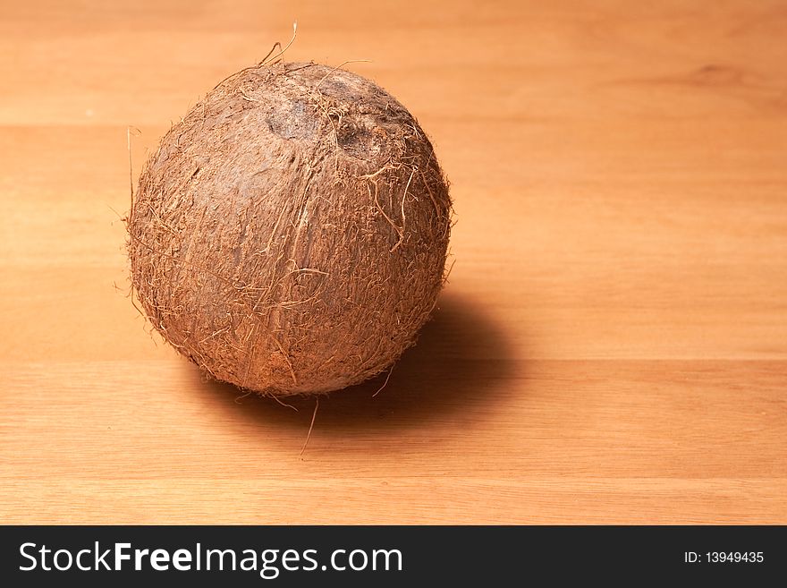 A fresh uncut coconut on a table