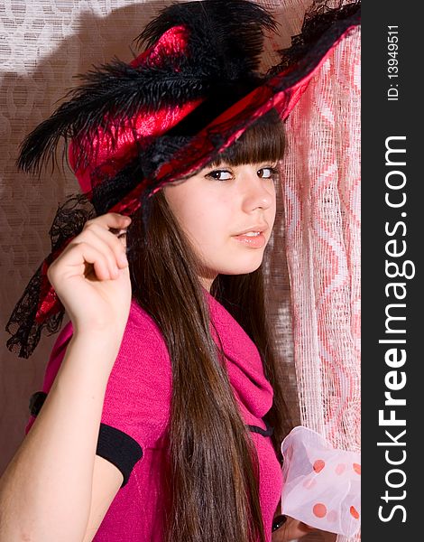 Lovely teen girl in pink dress and hat