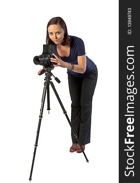 Photo of beautiful girl working with big camera mounted on tripod. Isolation on the white. Photo of beautiful girl working with big camera mounted on tripod. Isolation on the white