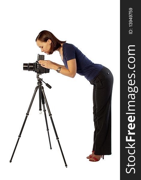 Photo of beautiful girl  working with big camera mounted on tripod. Isolation on the white. Photo of beautiful girl  working with big camera mounted on tripod. Isolation on the white