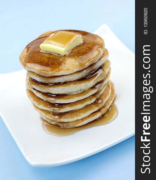 Fresh pancakes isolated against a blue background